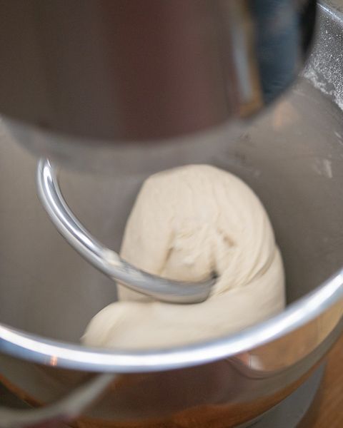 The dough is coming together add oil and salt.