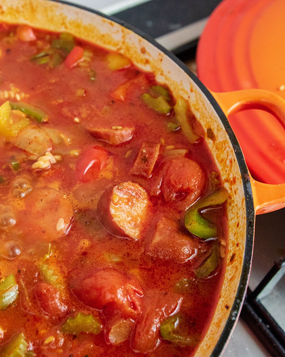 Add tomato and liquids to rice